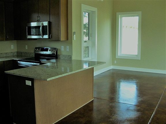 Kitchen, corner of living room or dining area.