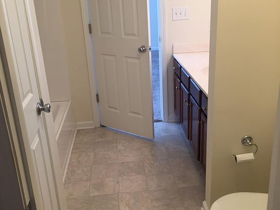 Master bath has shower, tub, vanity and commode