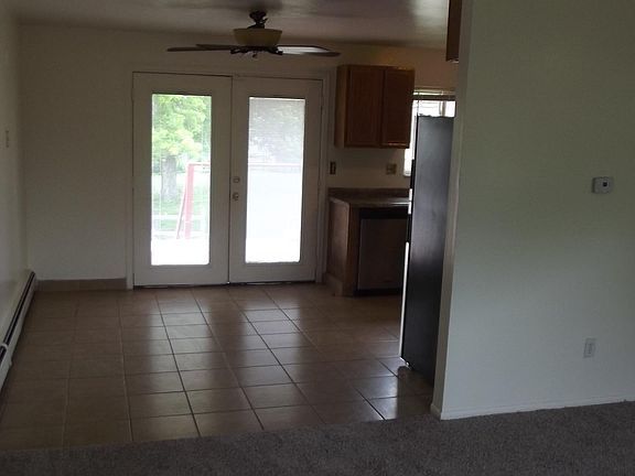 Dining Room and Main Entry Door Leading to Rear Deck with Stairs (Both Doors Open for Easy Move-In)