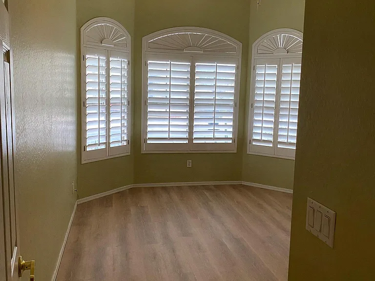 Bedroom 2. Plantation shutters, Hunter ceiling fan with light, brand new L.V.P. laminate flooring and fresh paint. Picture taken November 16, 2023 afternoon.