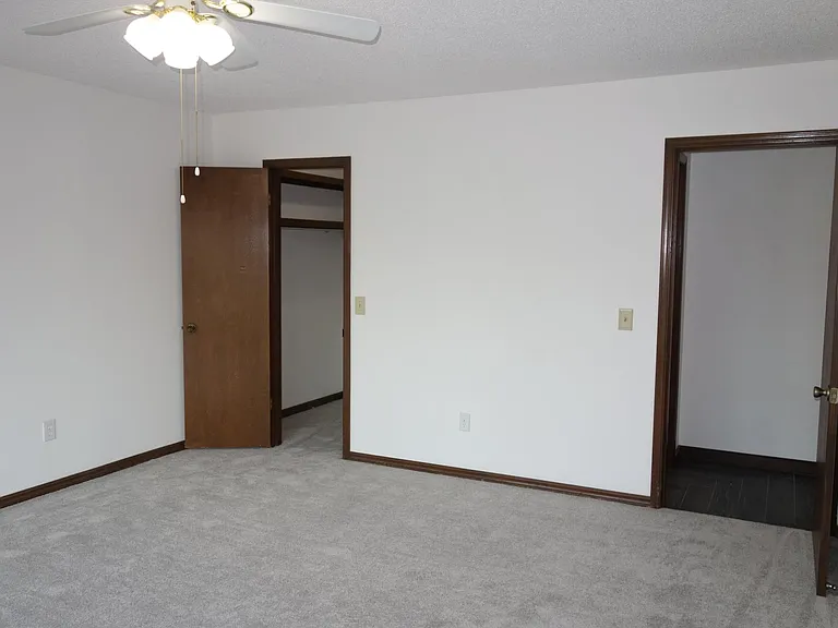 1st bedroom view. walk-in closet on left and hallway access on right.