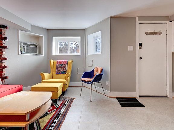 Living Room w/ front entrance and windows looking South