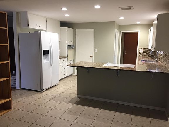Large kitchen with ceremic tile floors and large pantry.