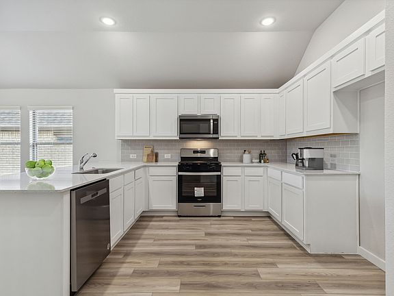 Kitchen in the Jade II home plan by Trophy Signature Homes - REPRESENTATIVE PHOTO