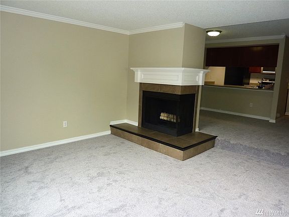 Living room looking back at dining area and kitchen