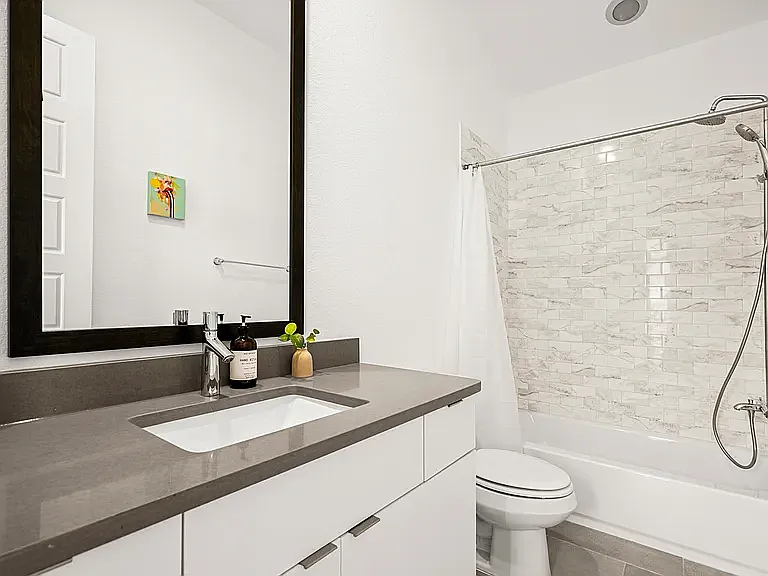 The spacious shared bathroom features a full tub and shower combination with plenty of room, making it ideal for family, guests, or roommates.