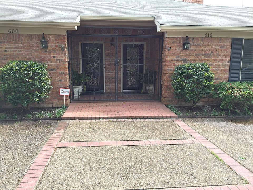 Front view of the duplex. It_s secured with a locked gate, additional parking in the circle driveway.