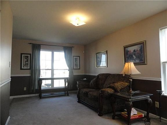 Front Living Room w/ Multiple windows for lots of day light