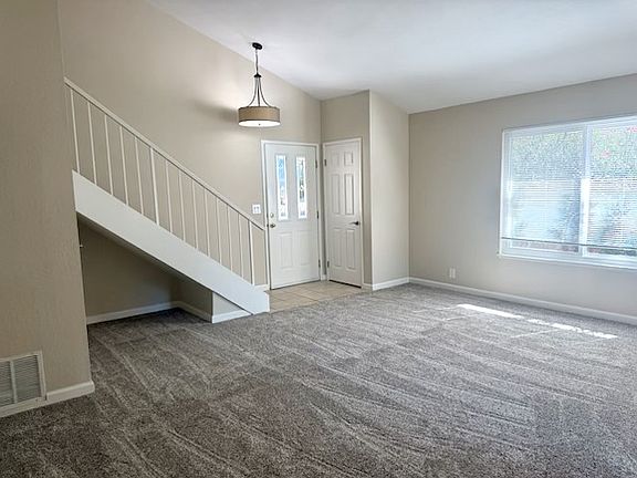 Spacious living room with brand new carpet
