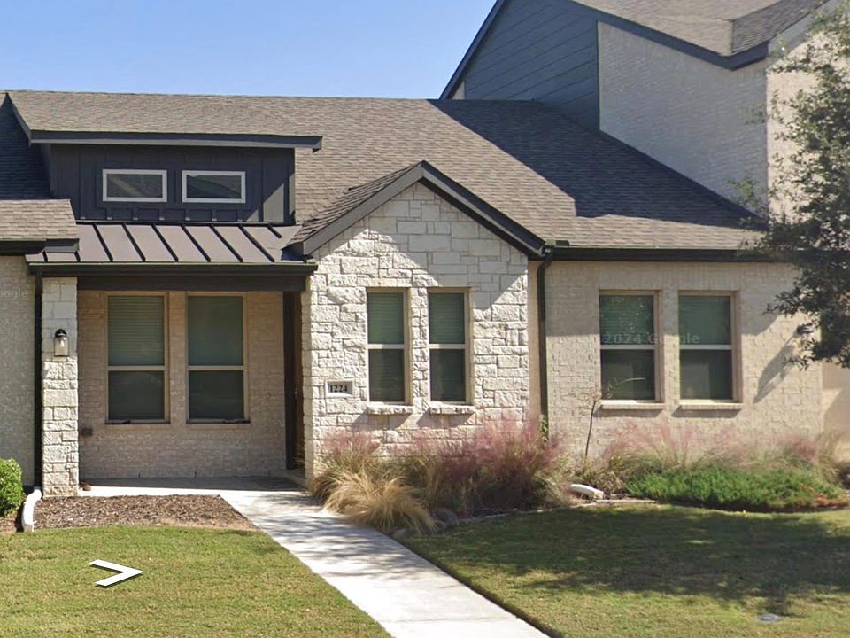 View of front of home featuring stone siding, roof with shingles, a standing seam roof, and a front yard