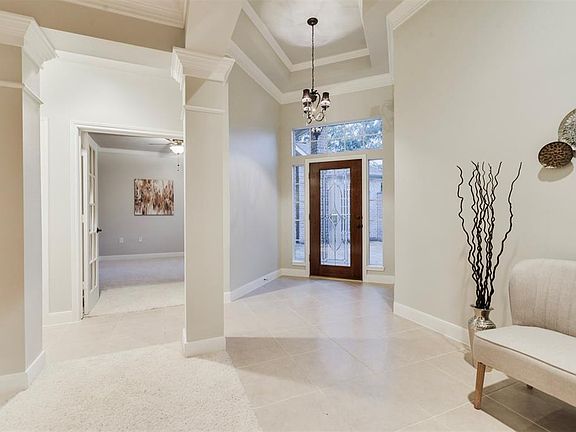 Through the Beveled Glass Door enter the freshly painted and modern looking home with popular designer light gray paint showcased by the abundance of White Molding and Trim. Raised Ceilings add to the elegant feel along with the tall windows that all