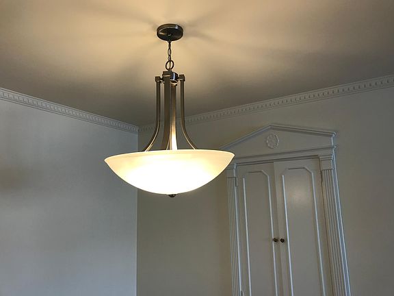New Dining Room Light Fixture next to Built-in Cabinets
