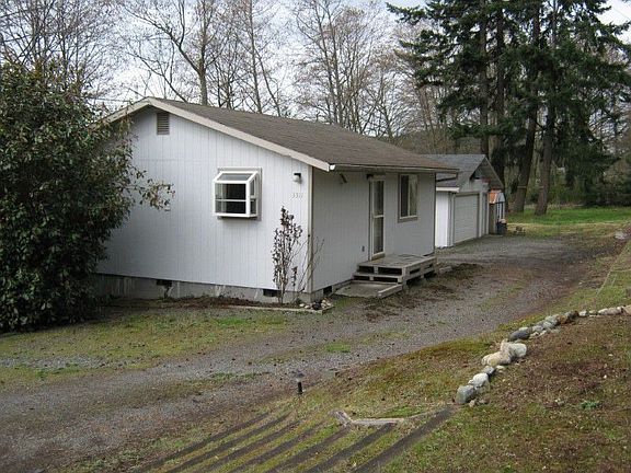 Front showing driveway and garage next to home.