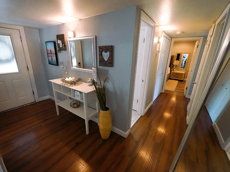 To provide prospective renters a sense of the home's layout - this picture shows the front entry and main hallway (leads to bedrooms and baths)