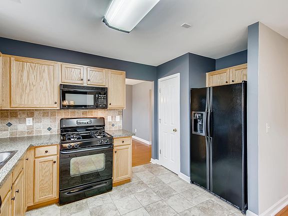 Kitchen has newer appliances, tile floor and a pantry closet.