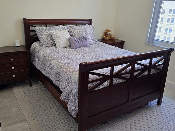 Bedroom with walk-in closet access to the left and an enclave space.