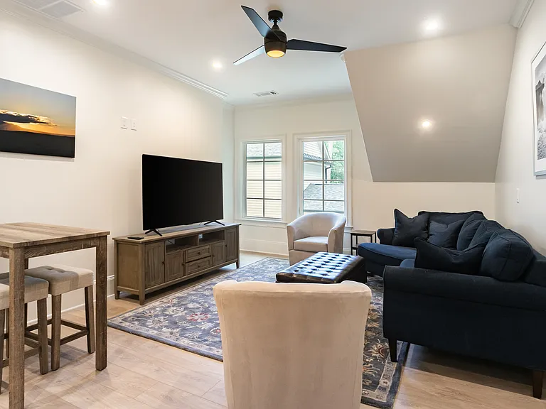 Fully furnished living room and dining area. Large 65" TV.