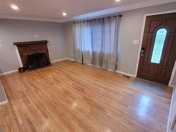 Living room with wood fireplace and front door.