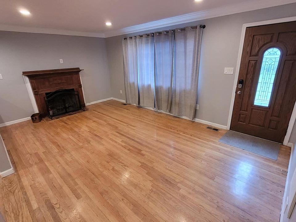 Living room with wood fireplace and front door.