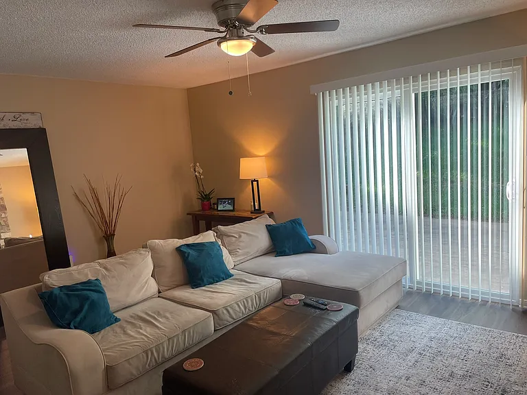 Main living area with sliding glass door to access the oversize back yard. Room for dining and living area.