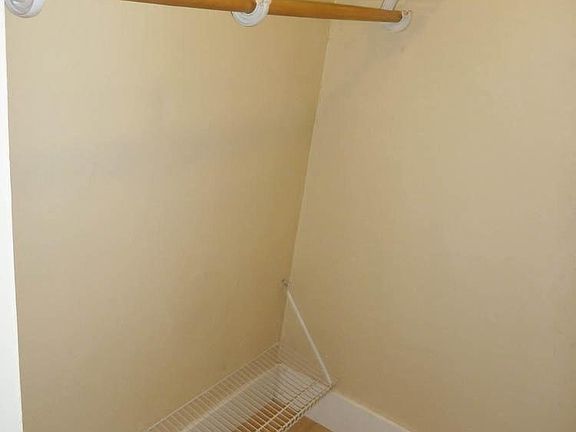 Walk-in closet in smaller front bedroom.