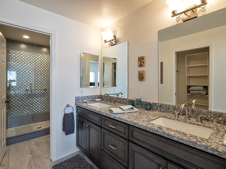 Primary bathroom vanity, shower beyond.