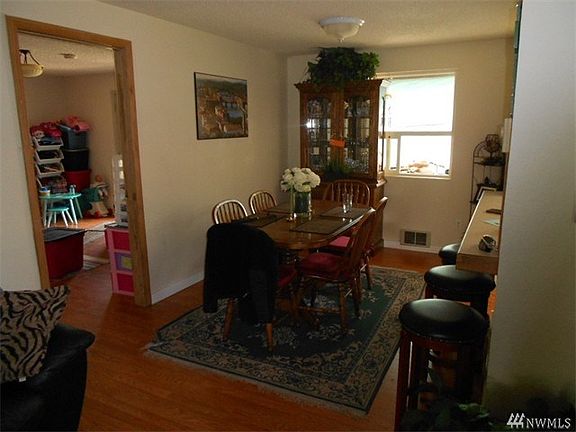 Dining room area with kitchen and eating bar to the right and Den to the left.