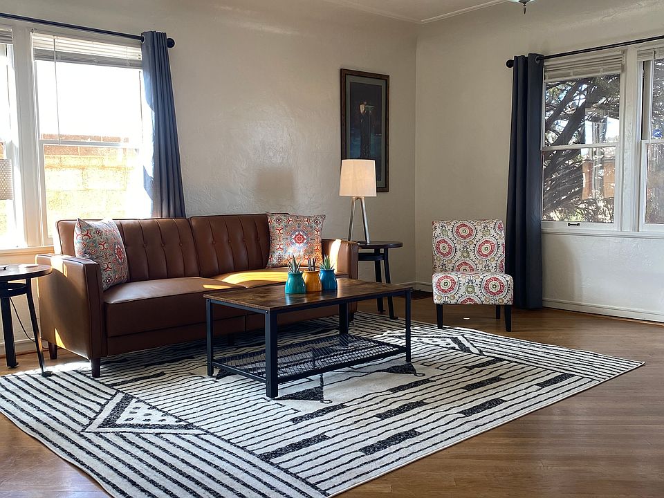 Comfortable couch and two stuffed chairs in the living room. There is a smart TV in the livingroom as well as in both private bedrooms