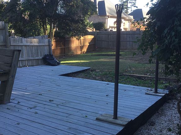 large deck in fenced back yard