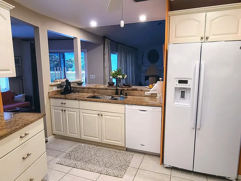 Double door fridge with ice and filtered water in the door. Pantry and trash bins