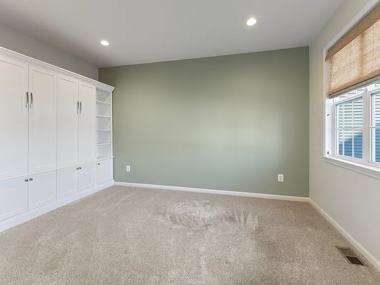 Dedicated office space with built-in shelving and a Murphy Bed