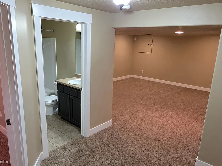 Basement with bedroom, full bathroom, and family room