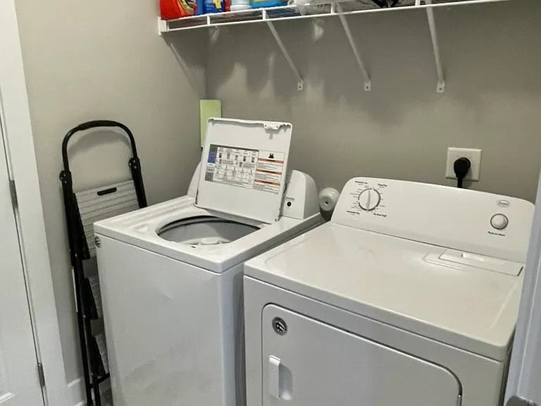 Laundry room with washer and dryer to remain.