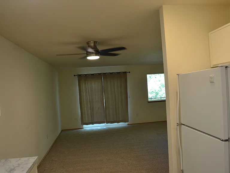 Dining area with ceiling fan/light.