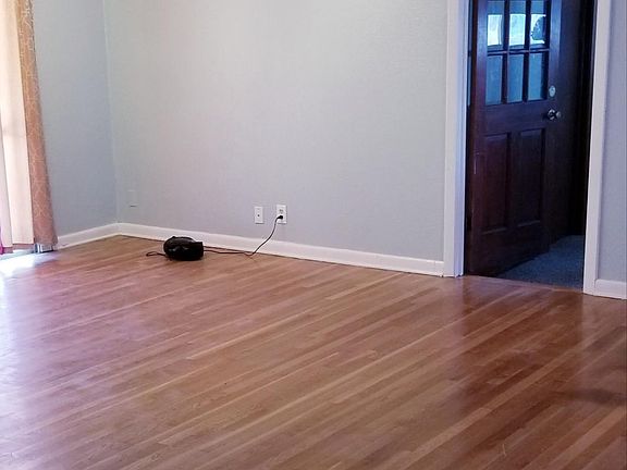 Entry opens to dining area with hardwood throughout.