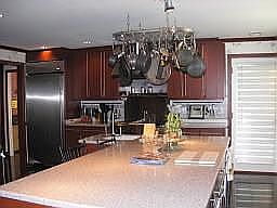 THE KITCHEN FEATURES CUSTOM CHERRY CABINETS & STAINLESS APPLIANCES!