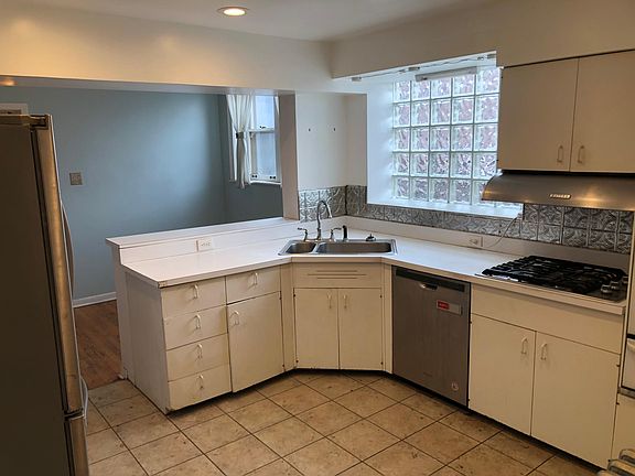 kitchen with dishwasher and gas range, breakfast nook in the rear