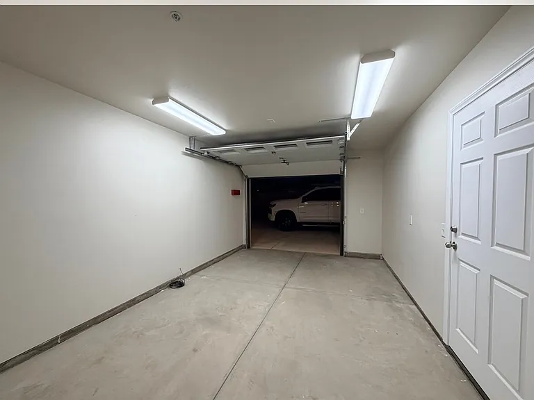 Attached single car garage leading to driveway