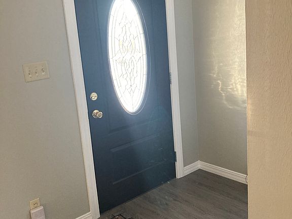 Front Door has oval entry viewing that allows looking out but darkens on the outside for no looking in the room and entry closet for coats and storage.