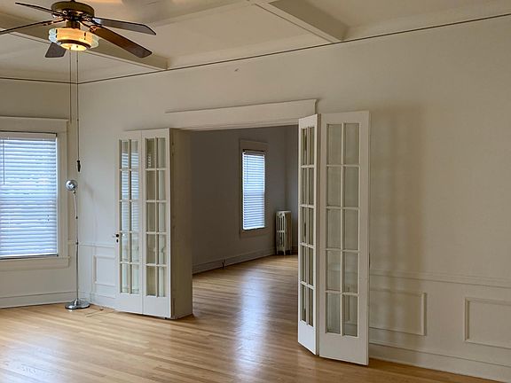 Dining room/ tv room. Coffered ceilings. French doors separate Dining from Living room.