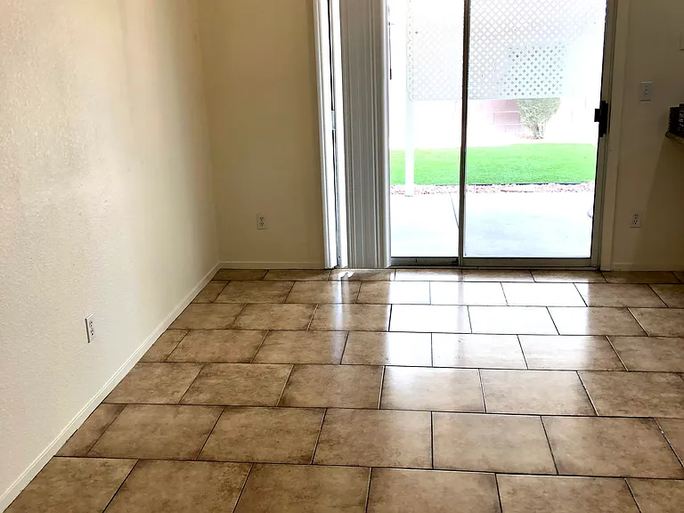 Dining room with sliding glass door to backyard.