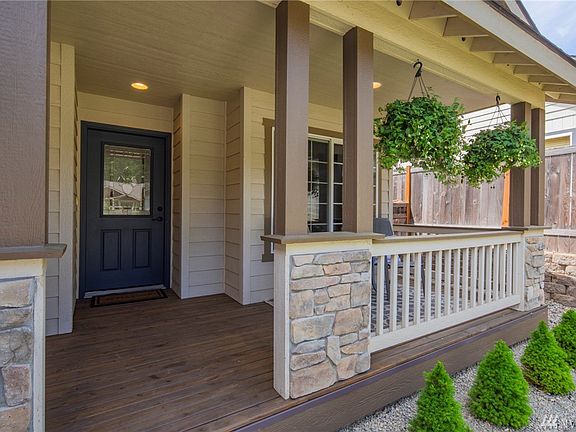 Welcoming & beautiful covered front porch! Lovely stone accents, newly fully finished!