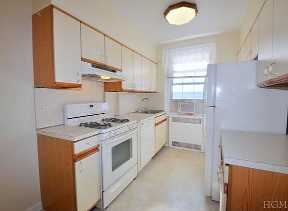 Large Eat-In-Kitchen has a dishwasher, range and refrigerator.