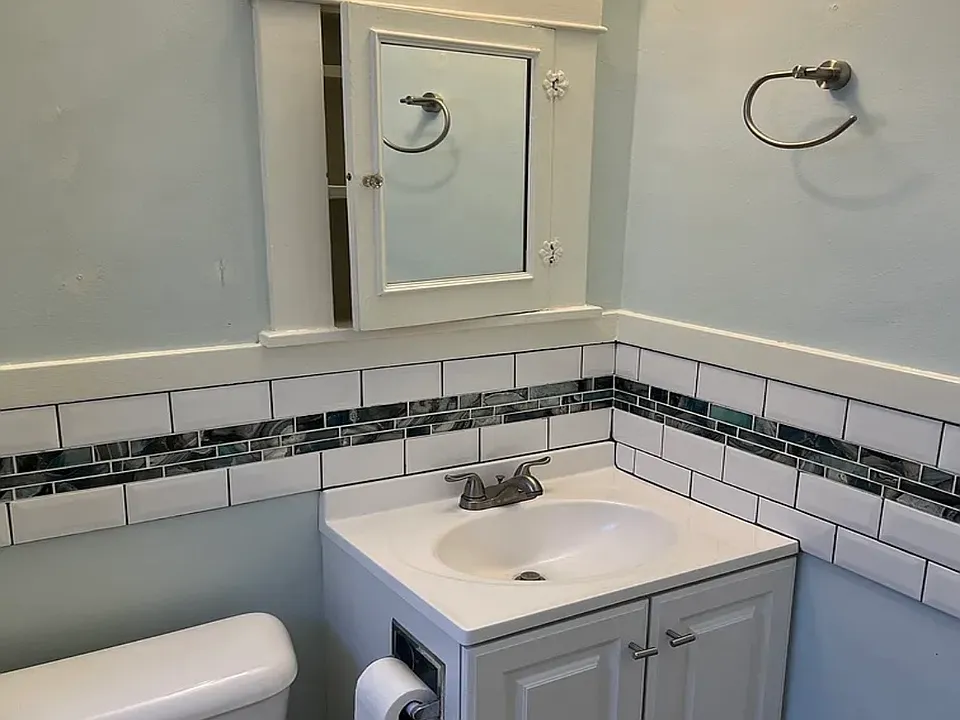 Newer sink, cabinet and ceramic accent tile.