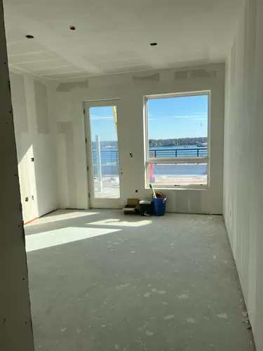 First peak at new Phase 2 PENTHOUSE. Sweeping views of the harbor from every room. This photo shows the master suite with a huge window and a door leading to the 691 square foot roof deck. - 383 Commercial St #610