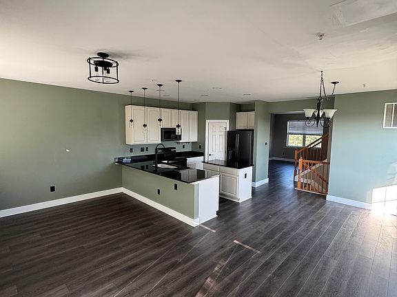 Overview of the Kitchen with a sitting area behind the bar. Walk in Pantry. Has a bonus 10x20 sitting area and a bump out for the dining room table.