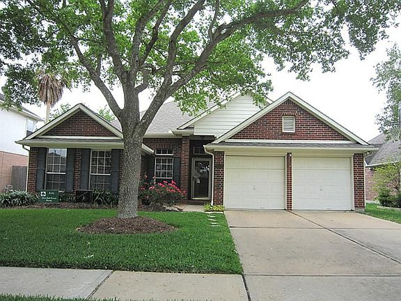 Double car garage and great front yard with large trees.