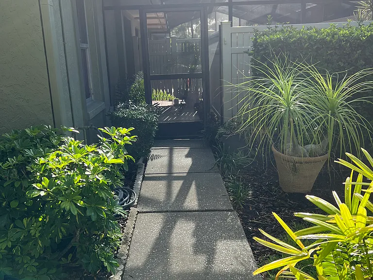 Private walkway to front door with screened gate that can be locked.