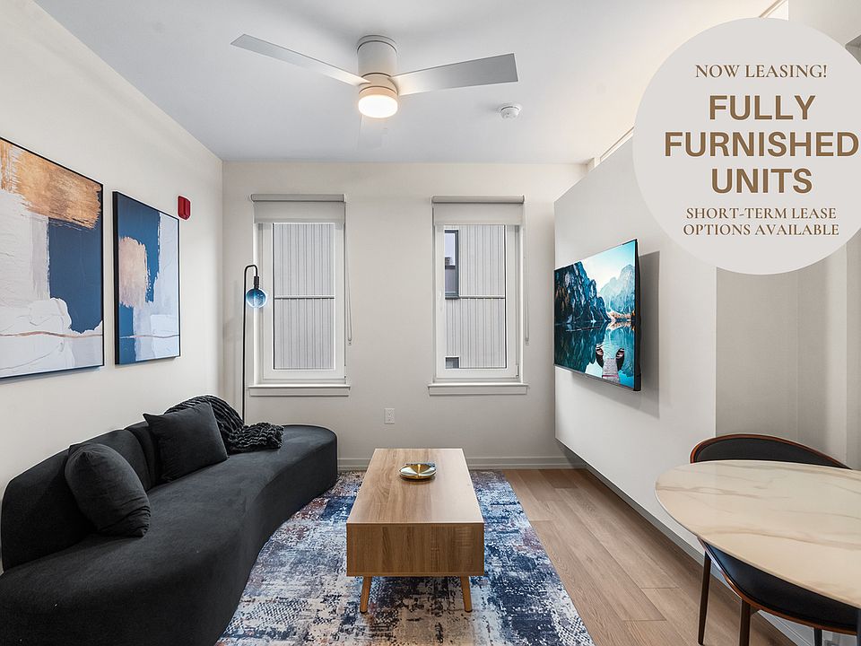 Living room with furnishings like couch, TV, coffee table, and dining table