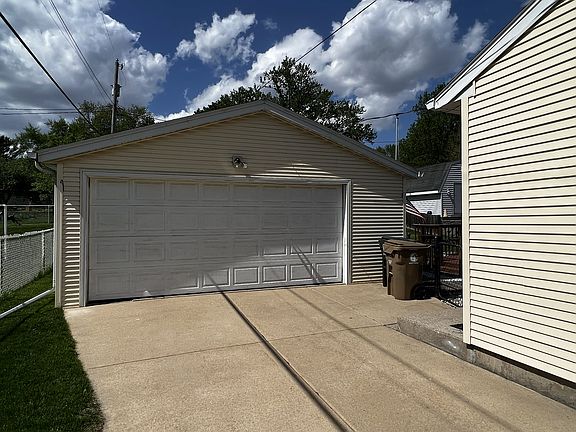 Spacious 2-car detached garage with work bench and off-street parking.